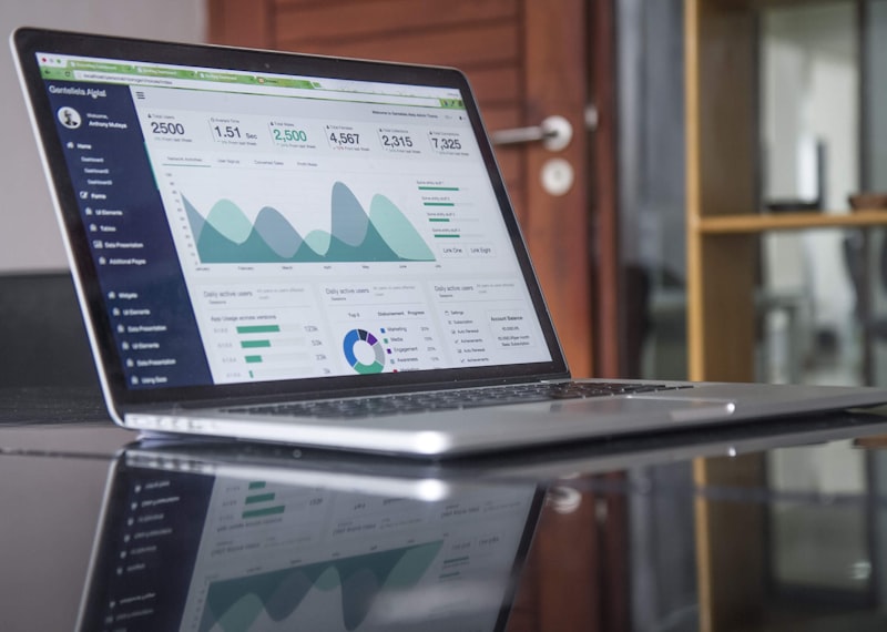 Stock photograph: an open laptop on a desk showing graphs