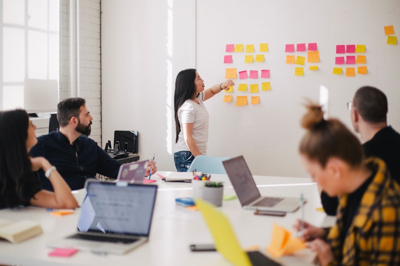Stock photograph: colleagues talking across a table in a meeting room